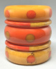 SZ13 Shultz yellow & orange bakelite dot bangles